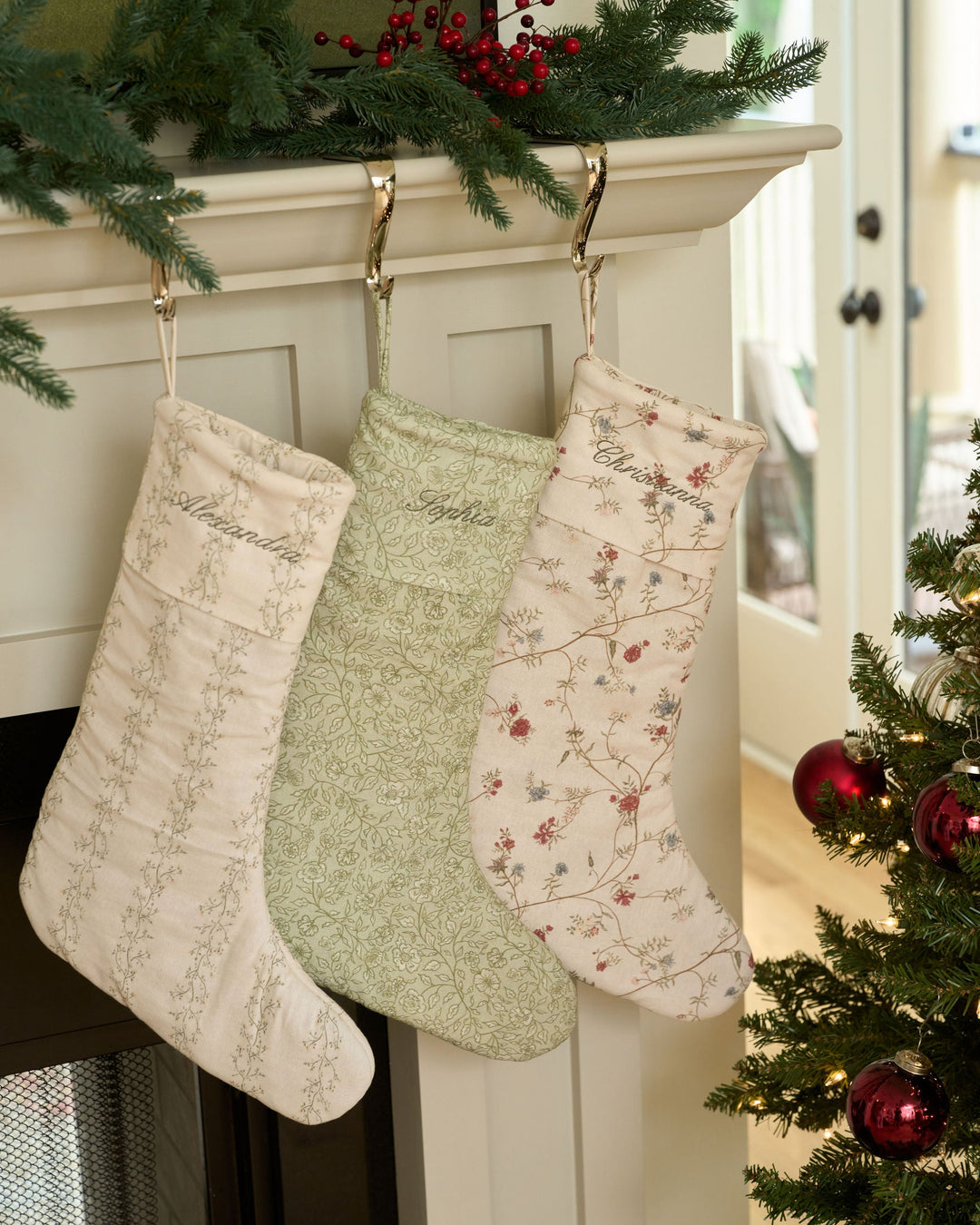 Green floral Christmas stocking with monogram name embroidery, softly structured holiday stocking, traditional mantel decoration, and personalized family Christmas decor.