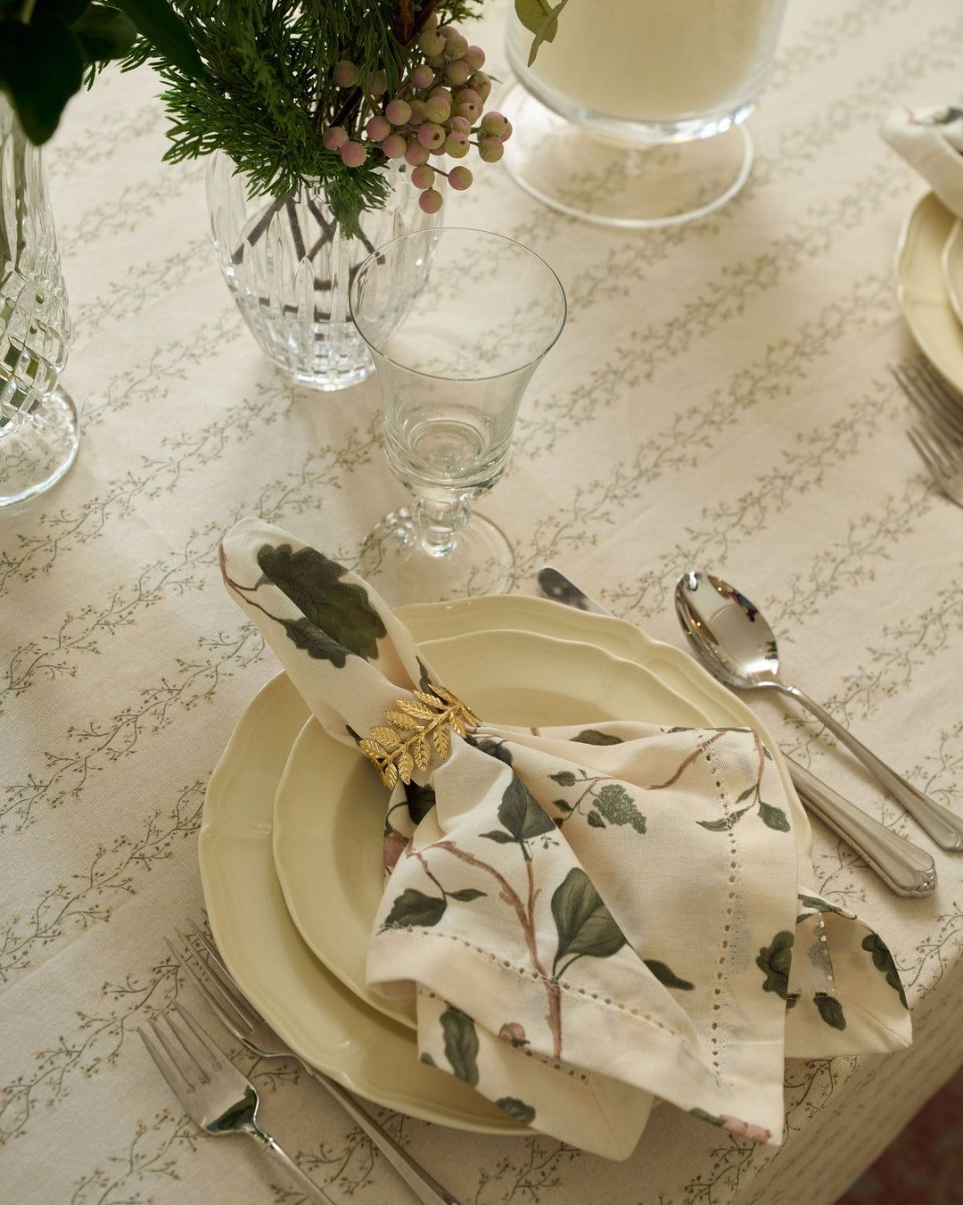 Arbor woodland napkins featuring green botanicals and winter berries for neutral Christmas tables, festive dinners, and cozy seasonal hosting.