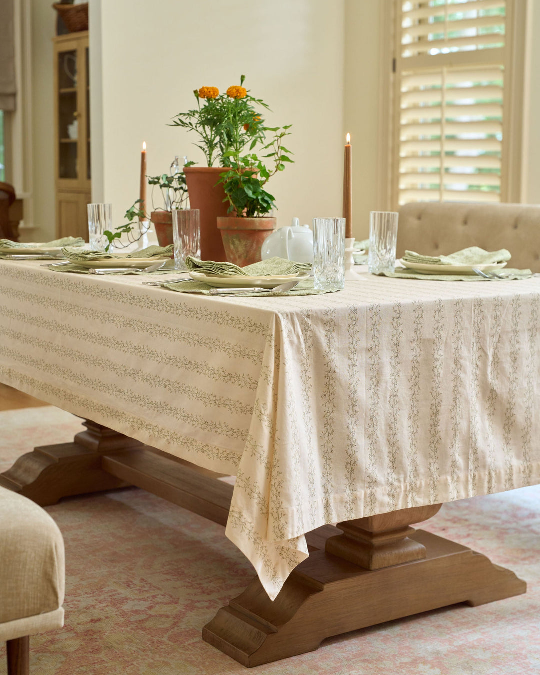 Green and yellow floral tablecloth with a neutral striped botanical print for spring dining and Easter entertaining.