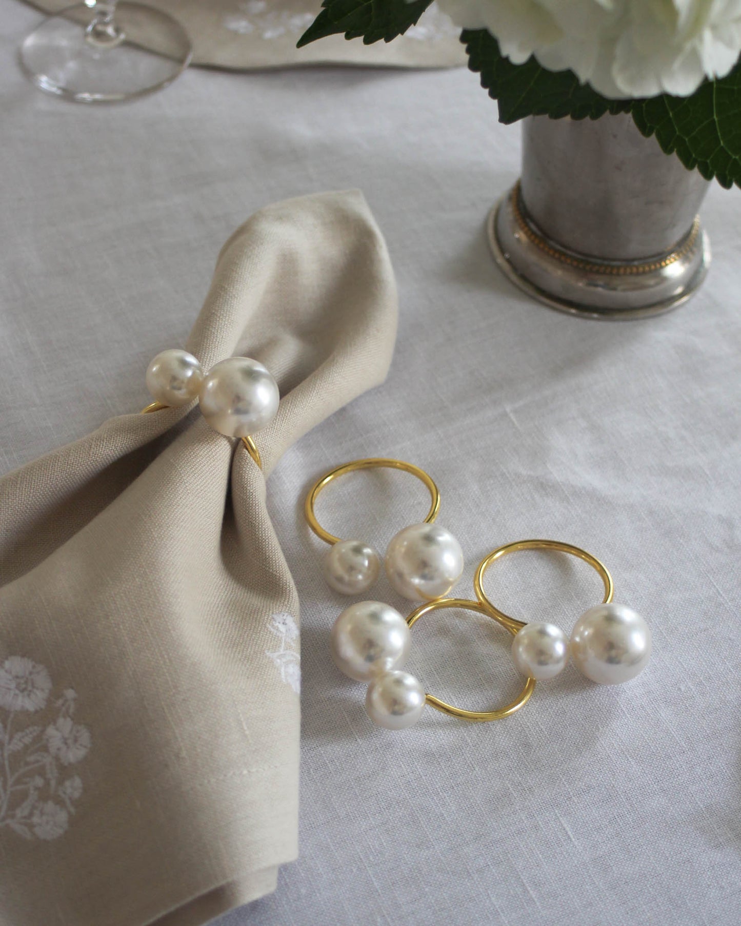 Add a touch of elegance to your Easter table with this charming set of napkin rings, featuring a stylish gold-tone design accented with delicate pearls. Perfect for spring gatherings and celebrations, they bring a festive and sophisticated flair to any tablescape.

