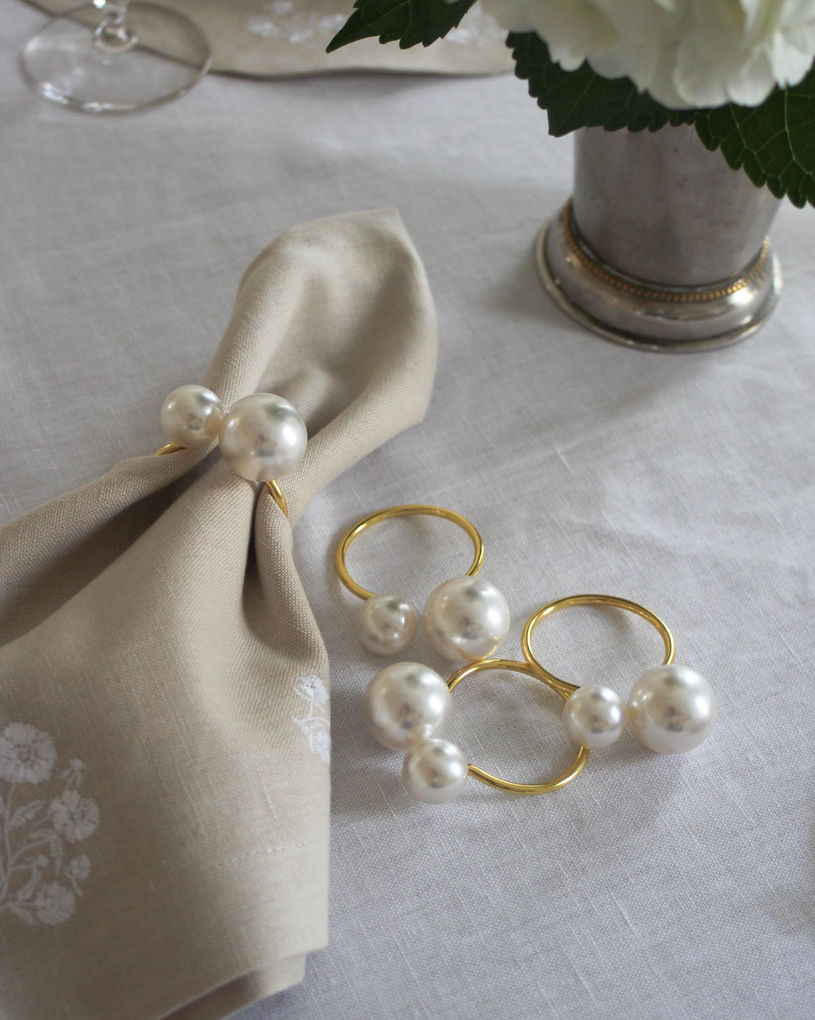 Add a touch of elegance to your Easter table with this charming set of napkin rings, featuring a stylish gold-tone design accented with delicate pearls. Perfect for spring gatherings and celebrations, they bring a festive and sophisticated flair to any tablescape.

