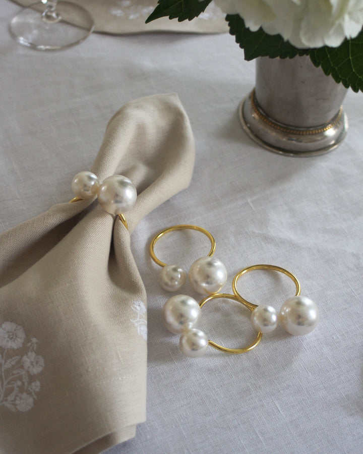 The perfect accessory for a sophisticated bridal shower or an afternoon tea party. These gold napkin rings with pearl accents bring a soft, elegant touch to the table that every guest will love. They look stunning paired with lace tablecloths, vintage teacups, and delicate finger sandwiches. Add a bit of shimmer to your "bride-to-be" celebration or bridesmaid luncheon with these charming rings that also make wonderful party favors for guests to take home and enjoy for their own meals.

