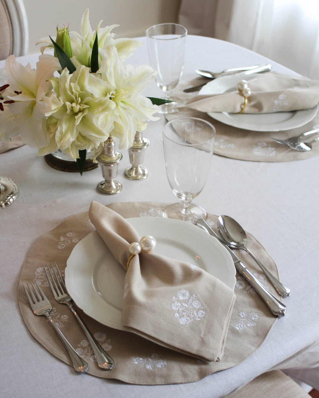 Set of elegant napkin rings featuring a chic gold-tone metal design with large pearl accents. These sophisticated rings enhance any table setting, making them perfect for wedding receptions, bridal showers, and engagement parties. The gold and pearl combination adds a touch of classic luxury to your special day. Ideal for brides looking for timeless wedding decor that complements white linens and floral arrangements. A must-have for a polished, high-end event aesthetic that guests will admire.