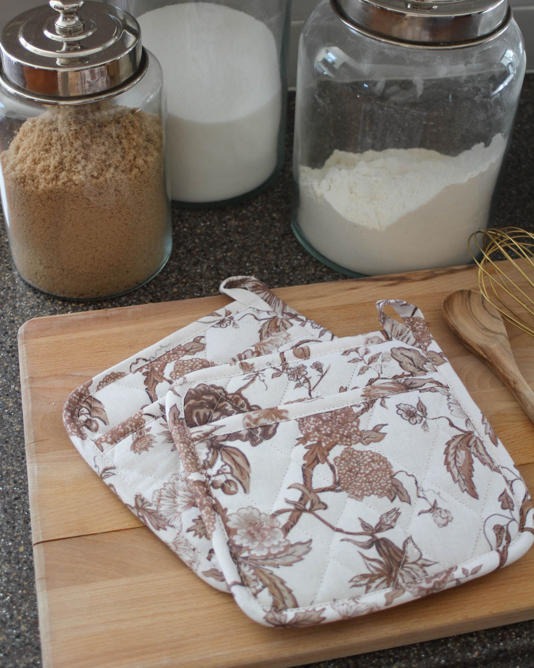Quilted brown floral pot holders with heat-resistant lining, ideal for baking, cooking, and cozy kitchen routines.