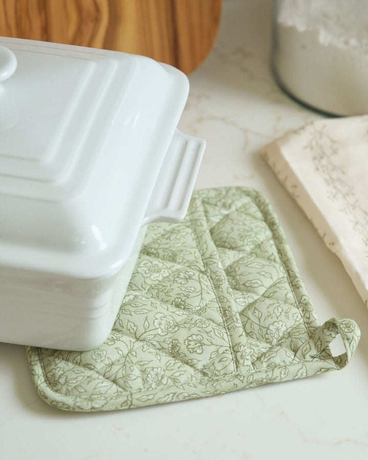Hand-drawn sage green floral cotton pot holders for year-round cooking and baking, featuring quilted durability and heat-resistant lining for hot pans, serving dishes, holiday recipes, Thanksgiving kitchens, Christmas gatherings, and coordinated kitchen linens.
