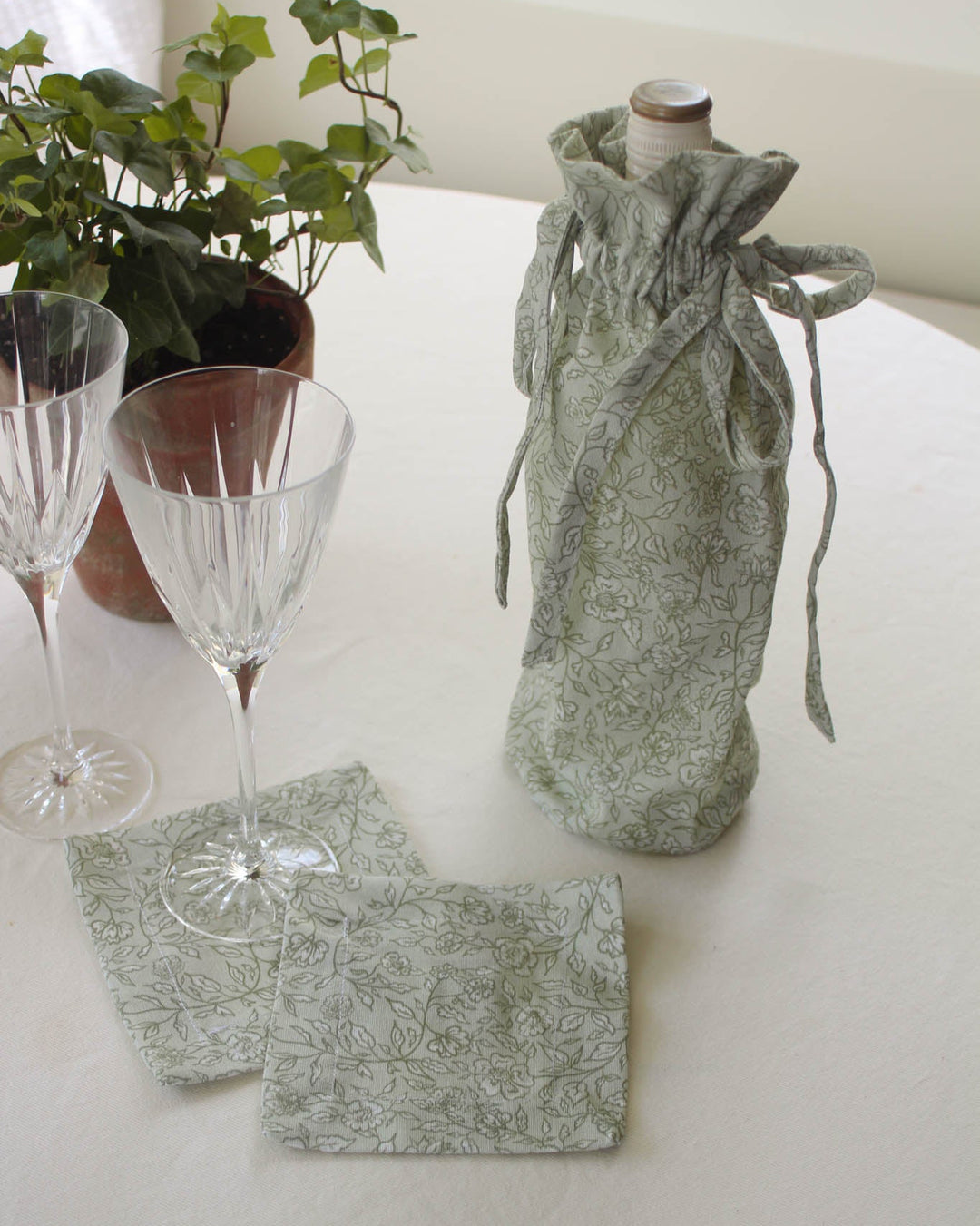 Floral fabric wine bottle bag crafted from cotton, perfect for hostess gifts, housewarmings, birthdays, and holiday entertaining.