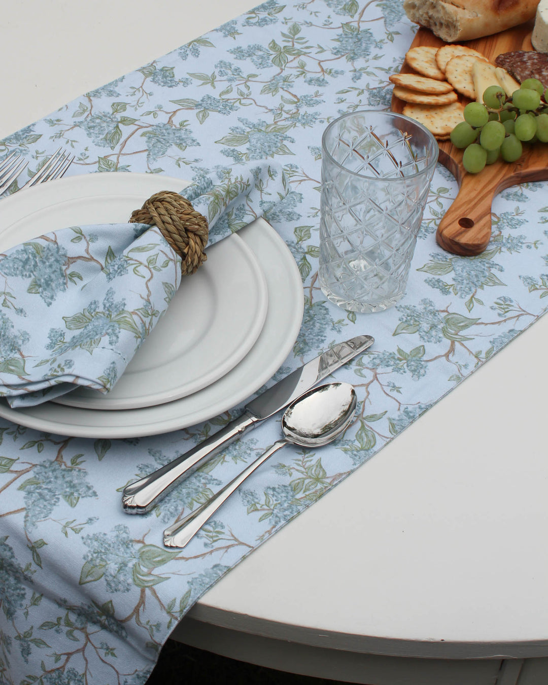 Create a seamless, high-end look at your wedding banquet with these blue floral runners. The Chinoiserie-inspired botanical design is printed on 100% organic cotton, offering a luxurious drape for long tables. Available in 120-inch lengths to accommodate large bridal parties and guests. The soft blue and green palette is sophisticated and romantic, coordinating beautifully with floral centerpieces and candlelight for a memorable, nature-inspired wedding reception.