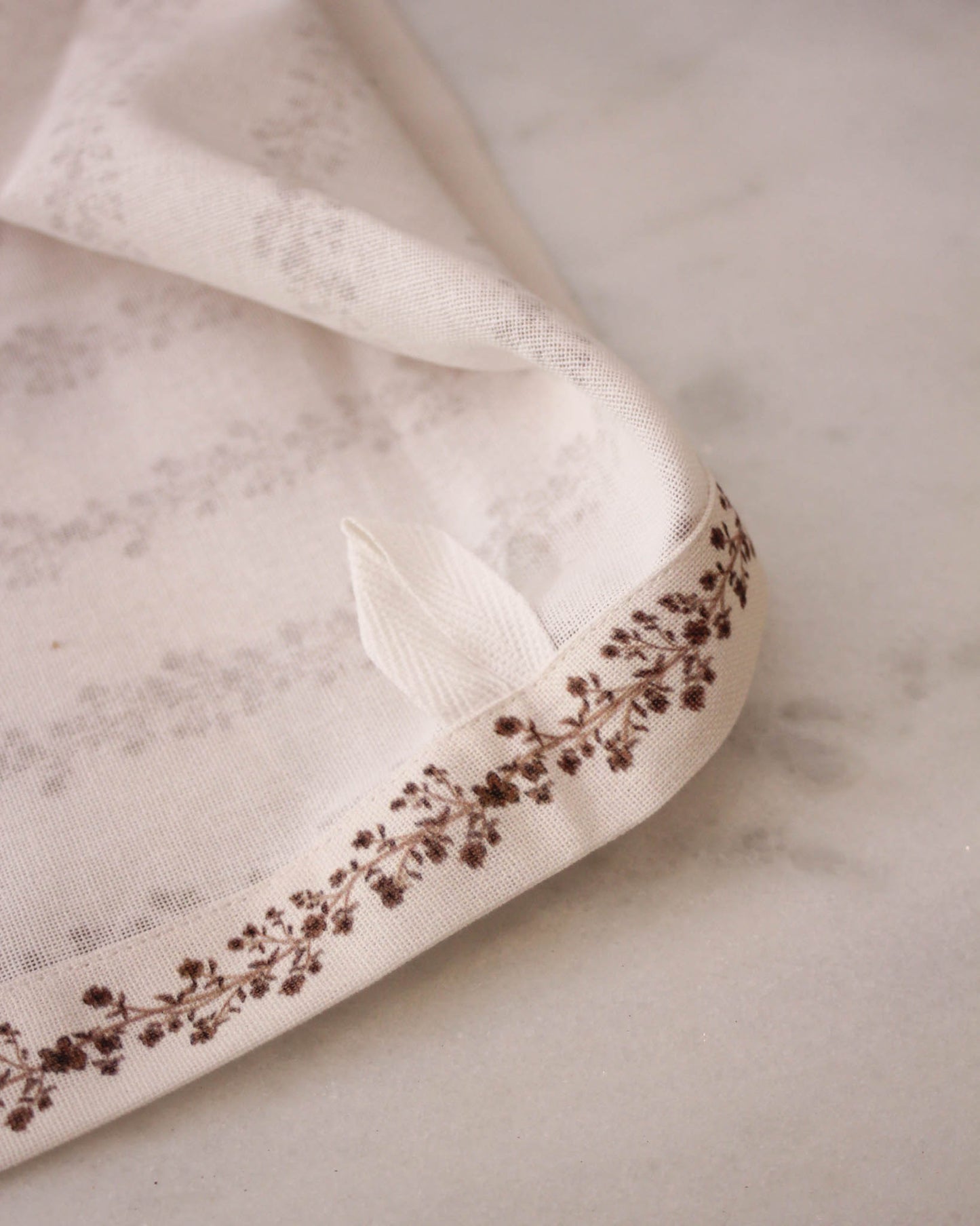 Begonia stripe tea towel in cream with coral floral pattern and loop